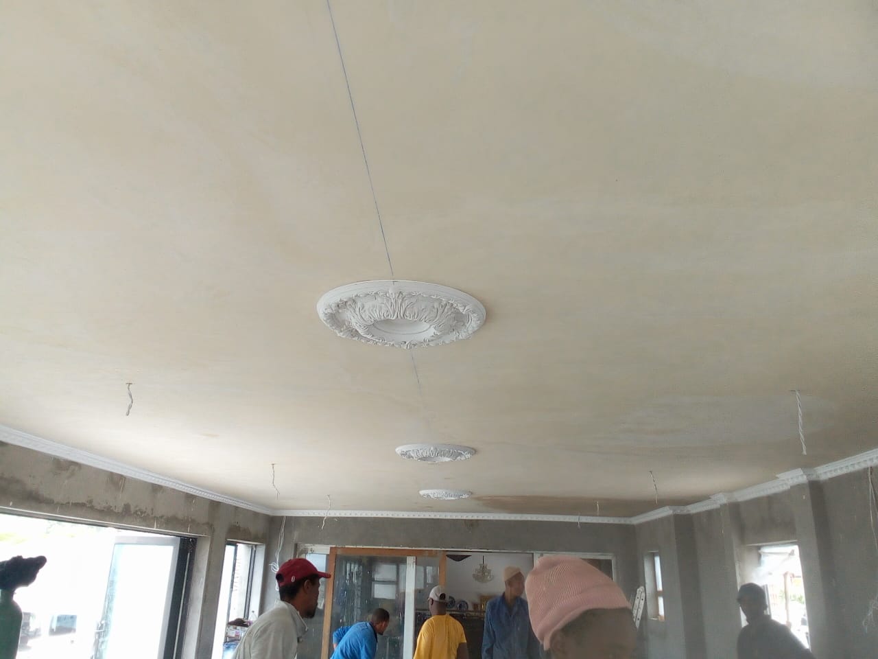Before: Suspended ceiling installers Port Elizabeth — decorative plaster rose medallions fitted on raw skimmed ceiling