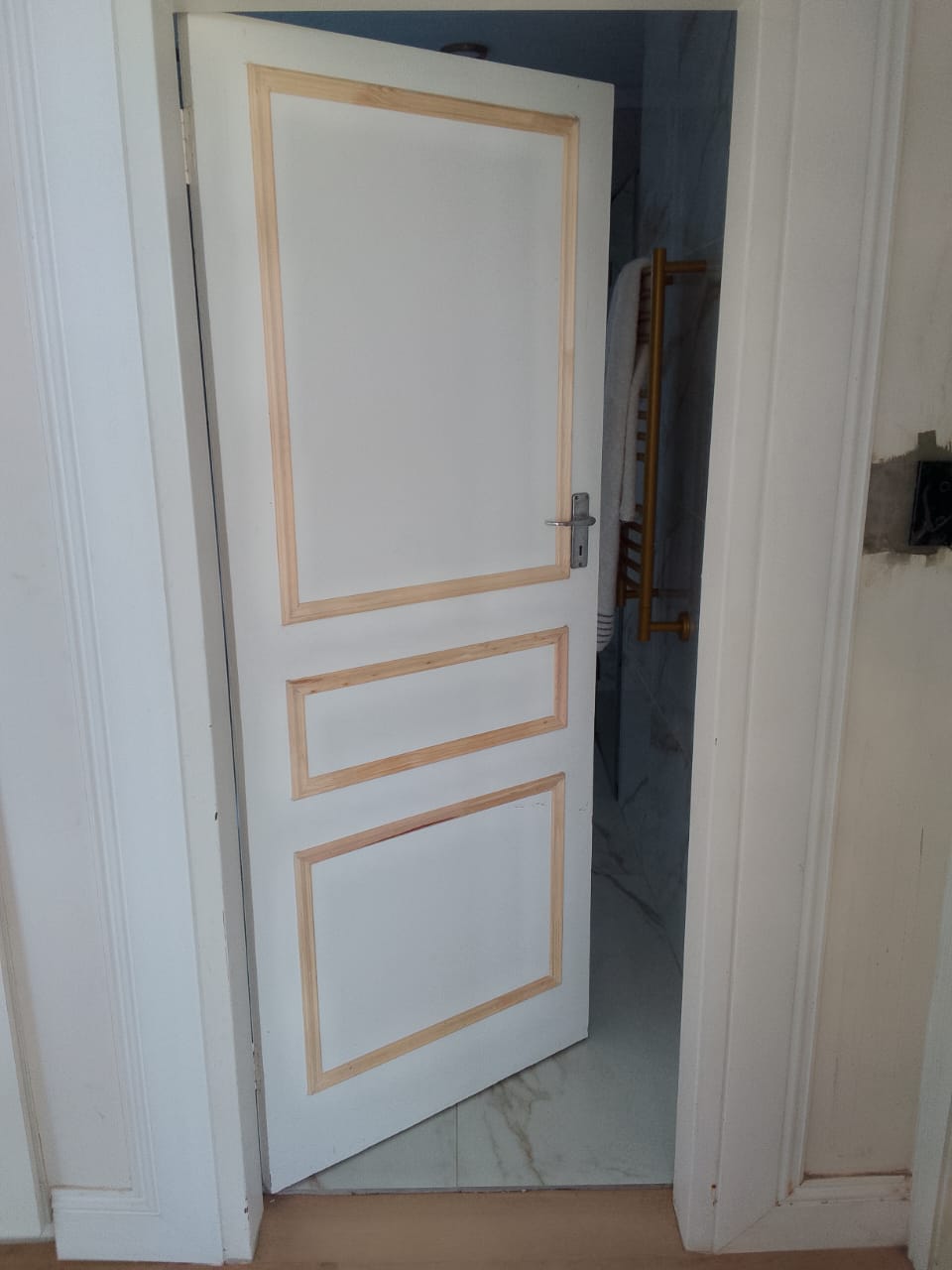Carpentry services Port Elizabeth — white painted 3-panel interior door with pine trim detail and wide architrave surround