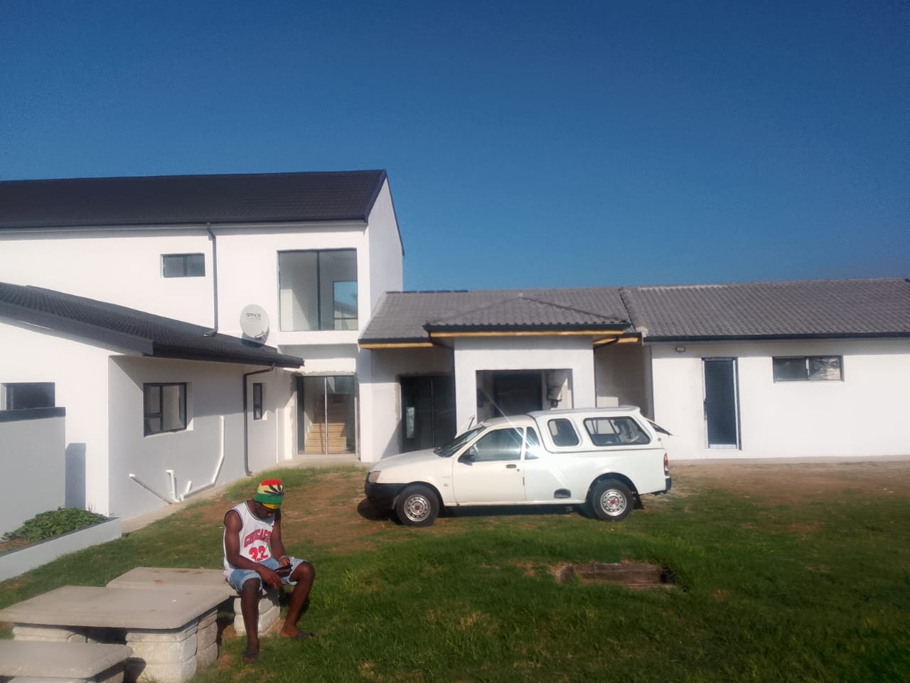 House renovations Port Elizabeth — completed white modern exterior with dark roof, built by Osflex Construction